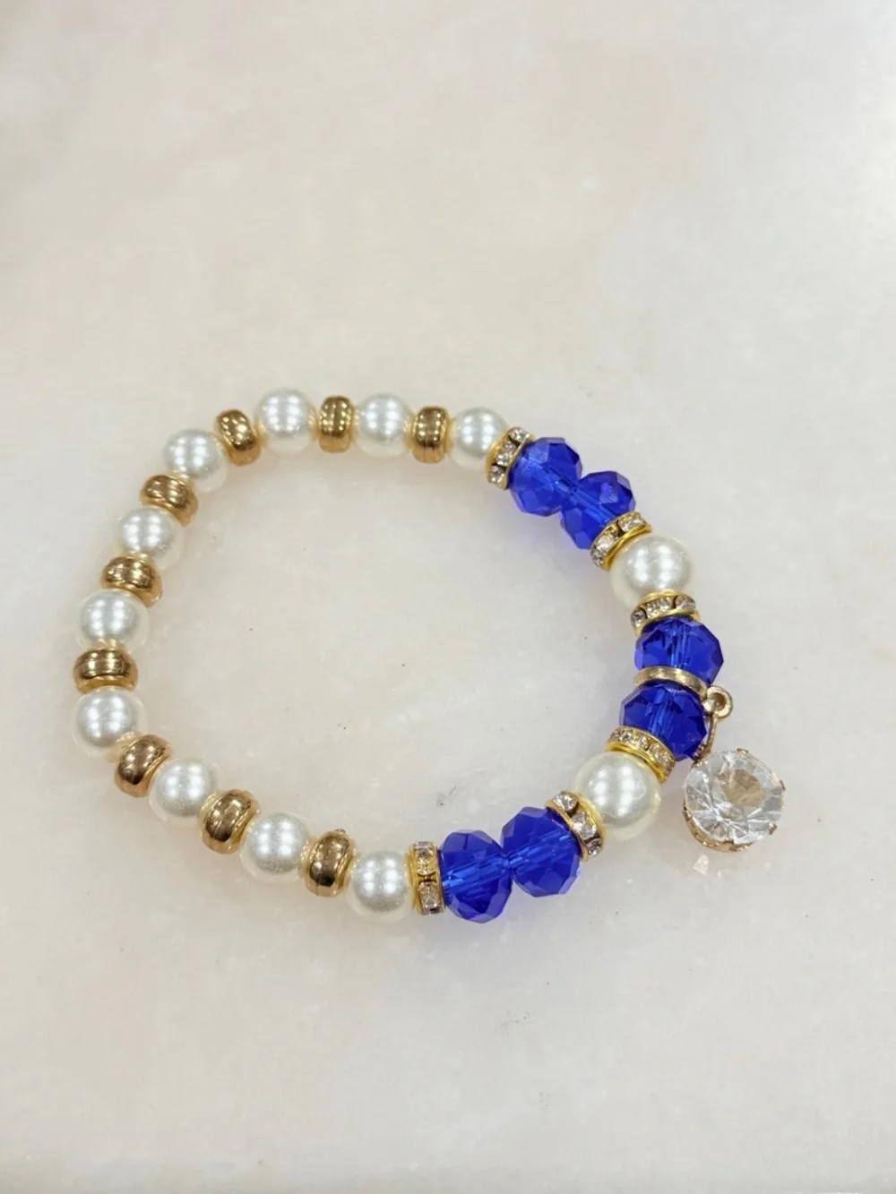 Gold and Pearl Beaded Stretch Bracelet with Blue Crystal Accents and Charm